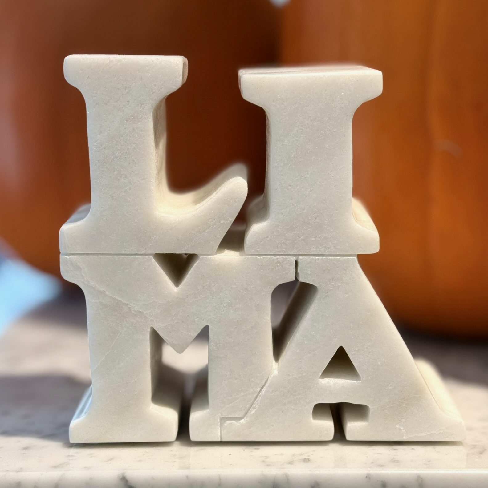 white figure that says "lima" for lima travel guide
