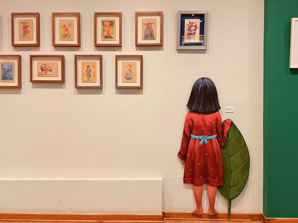 wall art of girl with leaf in art gallery lima peru
