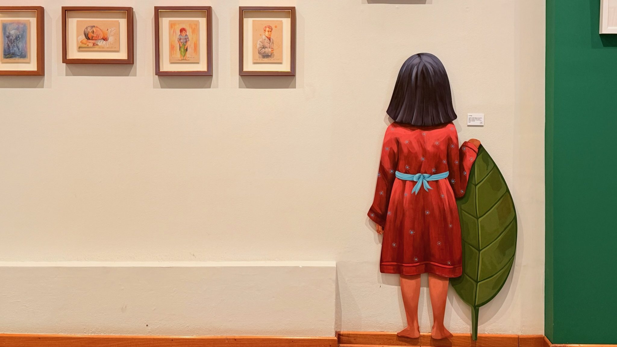 wall art of girl with leaf in art gallery lima peru
