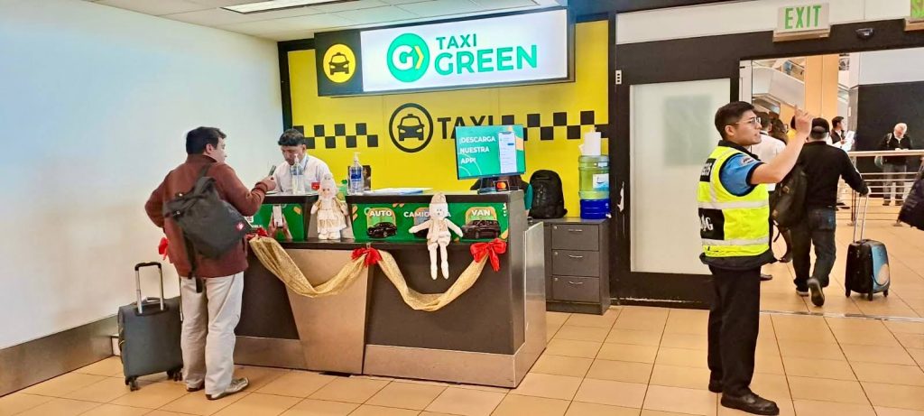 travelers at taxi green company counter in lima peru airport