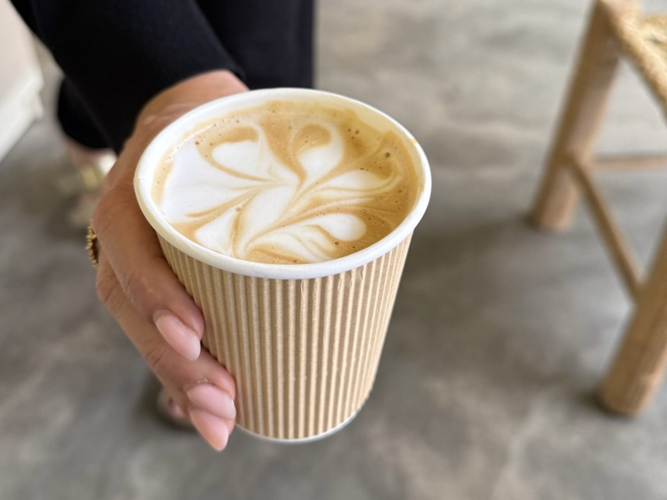 close up of woman holding cafe latte in lima peru