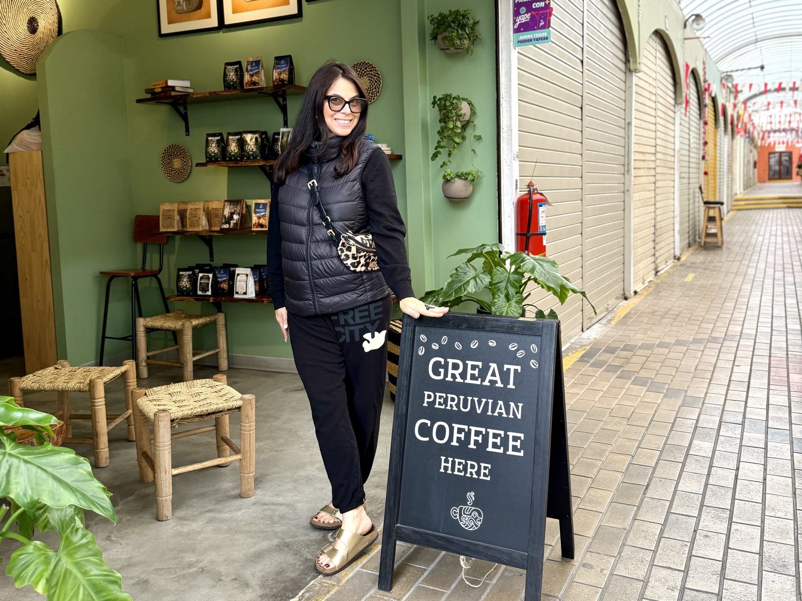 woman posing in front of gabriel coffee, one of the best coffee shops in Lima Peru