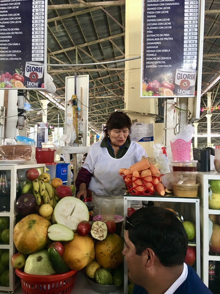 peruvian woman handling fruits for breakfast in lima peru