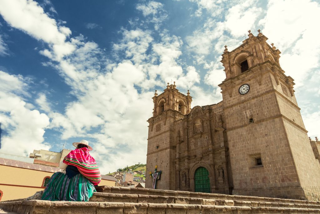 person sitting in front of historic building in lima peru