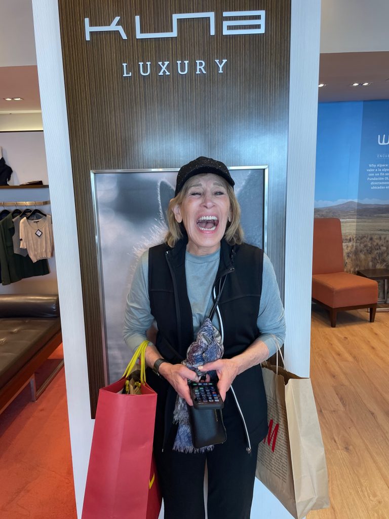 excited woman shopping in kuna luxury store, lima peru