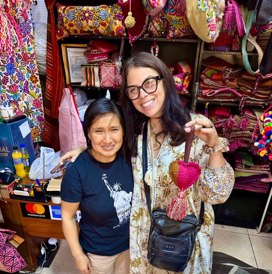 happy shopper and shop owner at inka market, miraflores district, lima peru