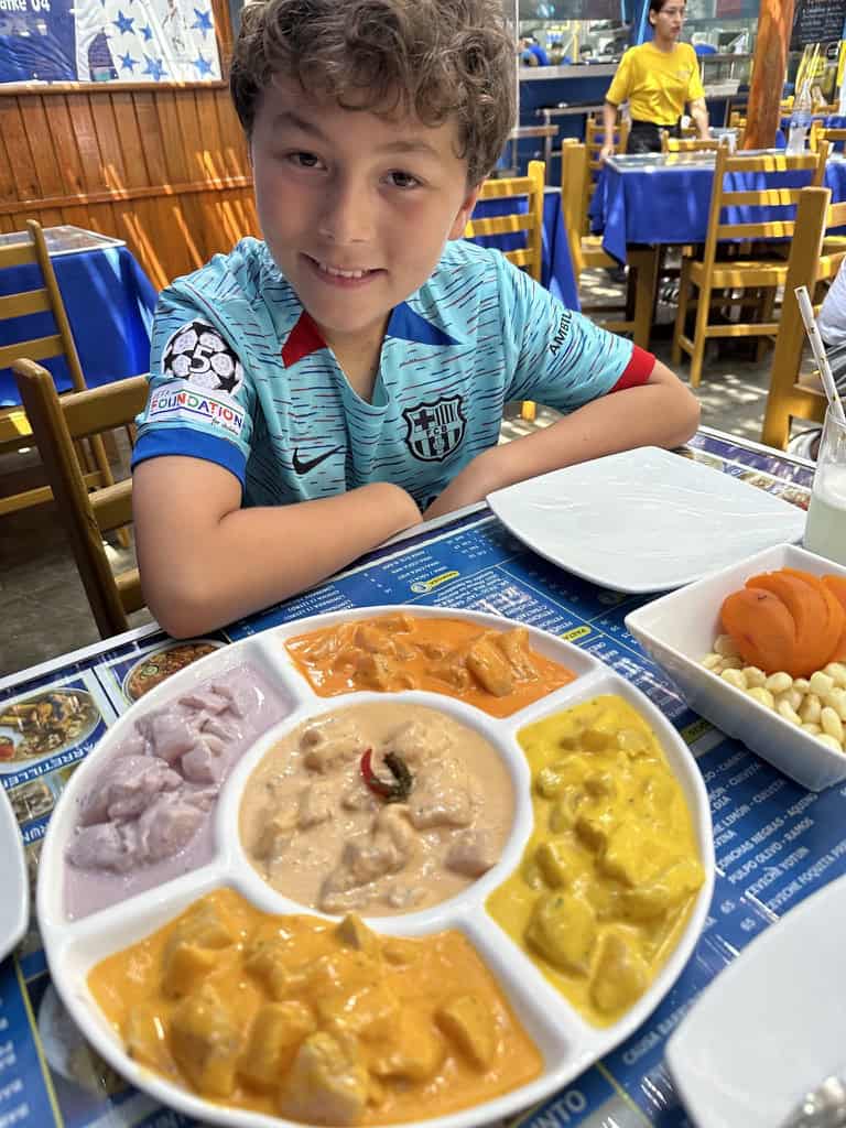 Young boy eating ceviche at MiBarrunto in Lima