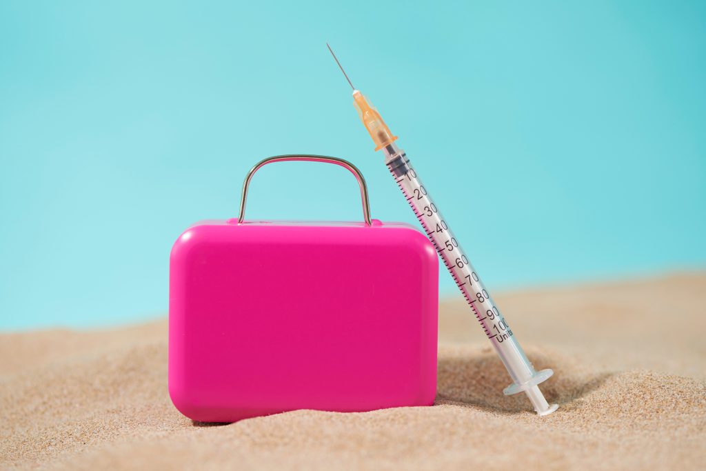 pink model suitcase with botox syringe