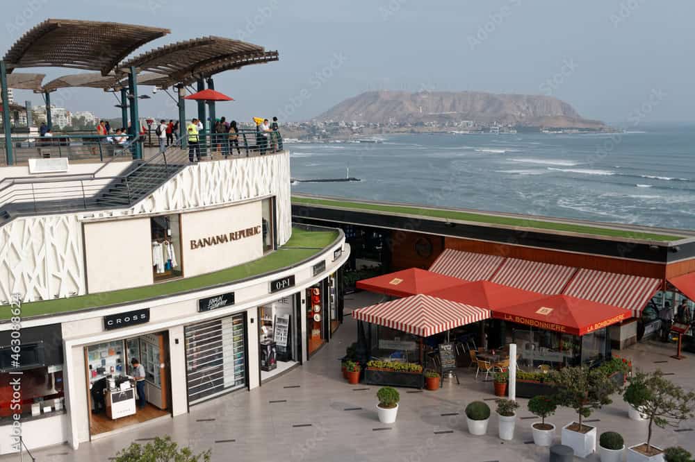 A wide shot of Larcomar from above, showing its cliffside construction and ocean backdrop.
