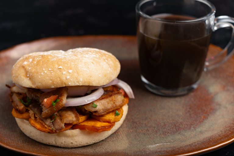 Pan con Chicharrón, famous lima sandwich in peru with beverage