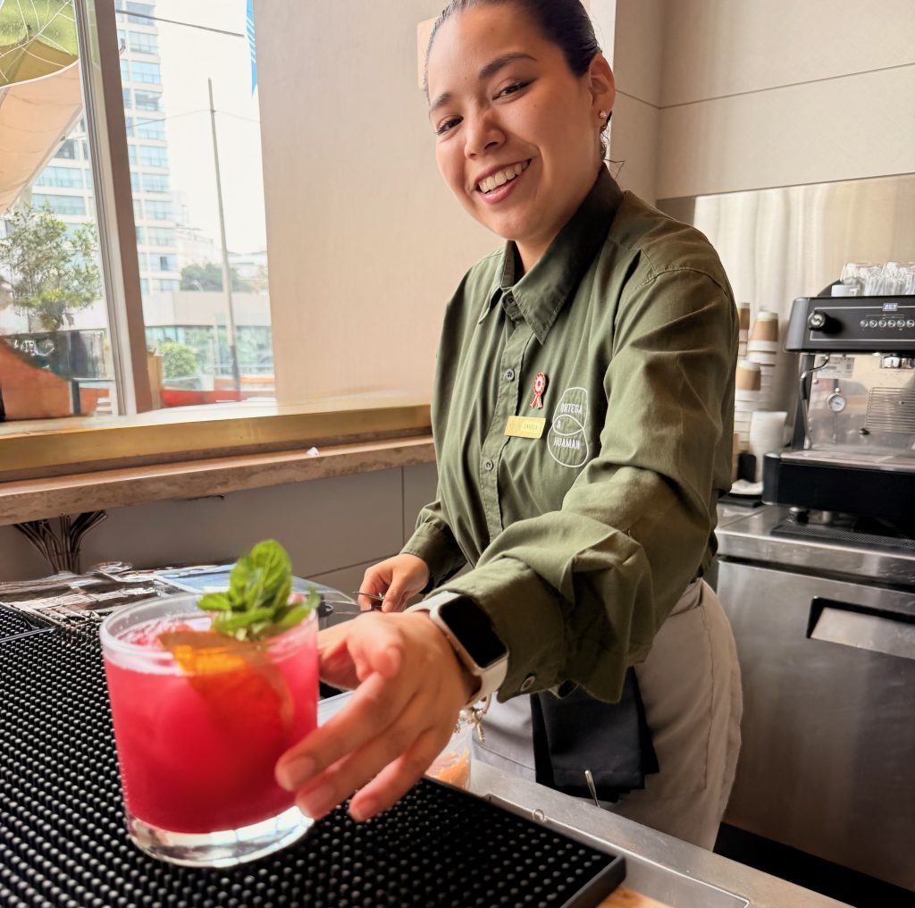 happy bartender handing drink over at Souma Hotel Boutique
