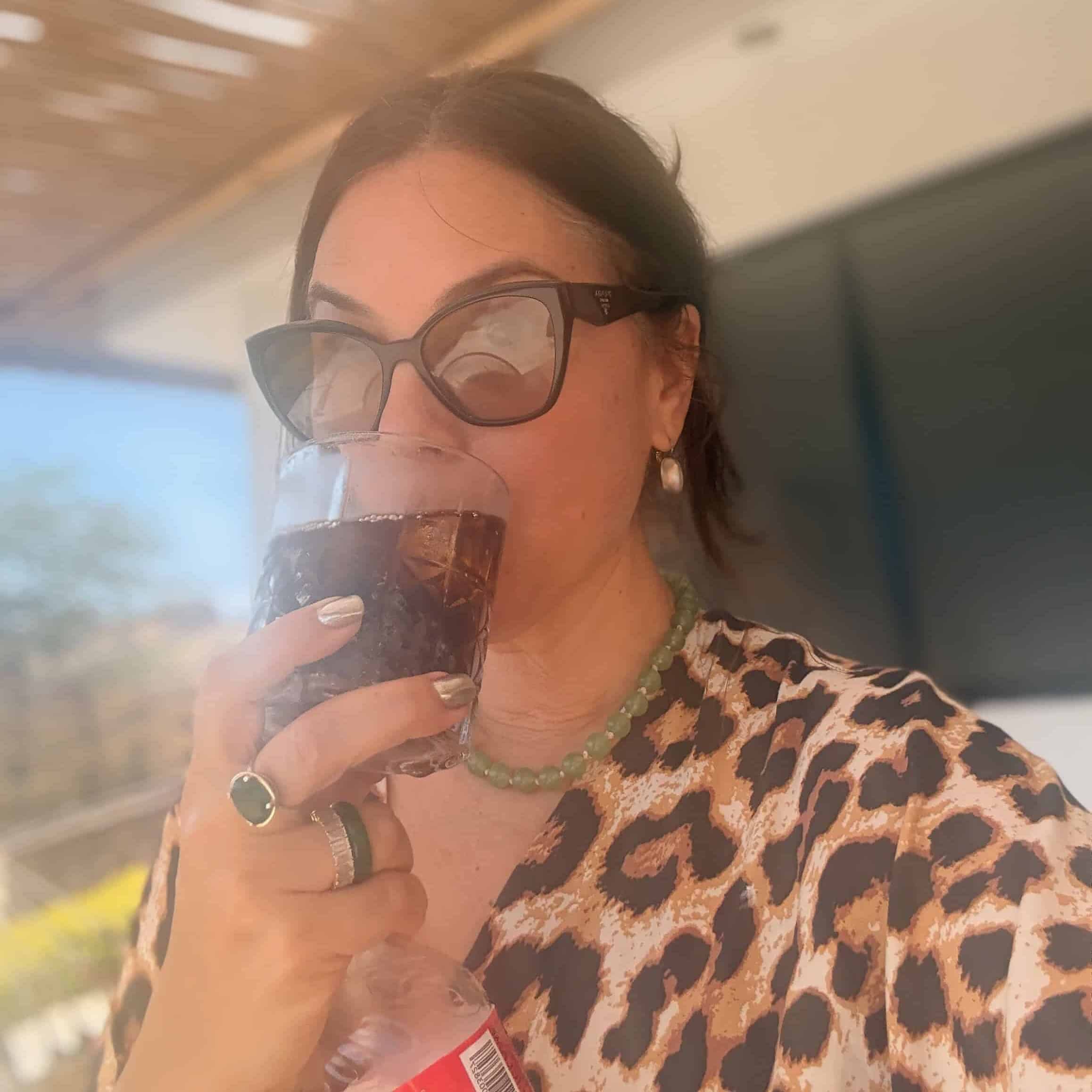 woman drinking diet coke chilled over ice