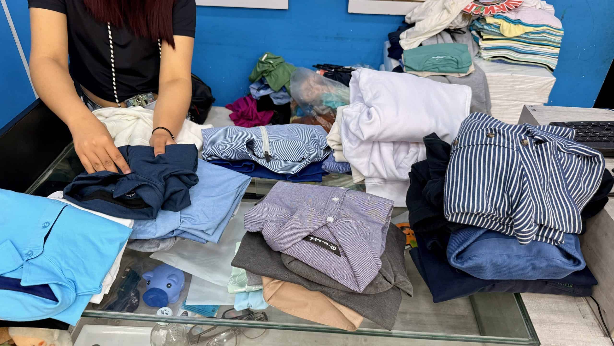 woman folding clothing from Abrego