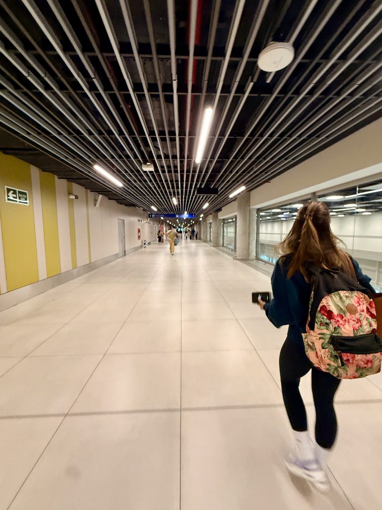 woman walking down long hallway at Lima airport
