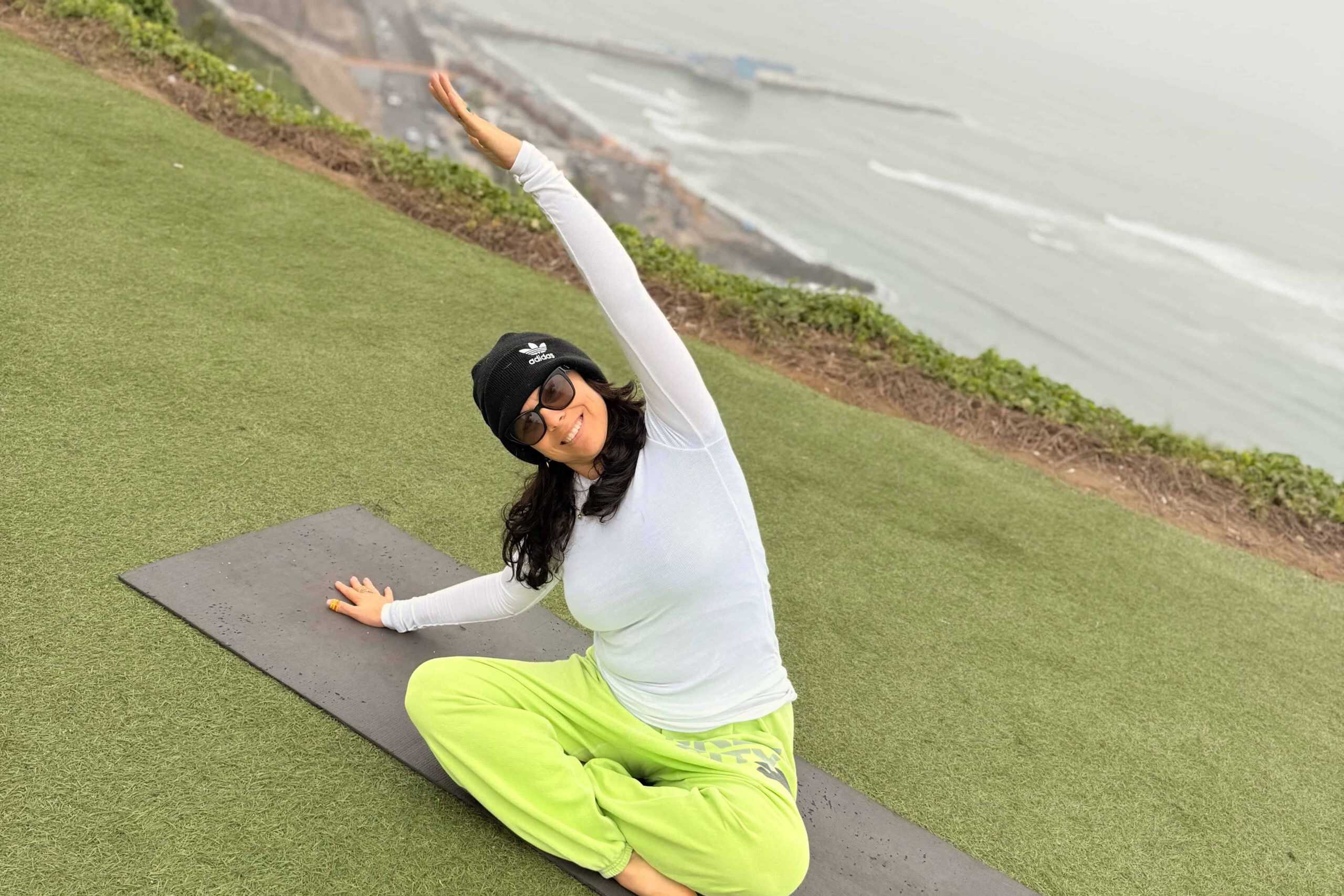woman practicing yoga along the Malecon