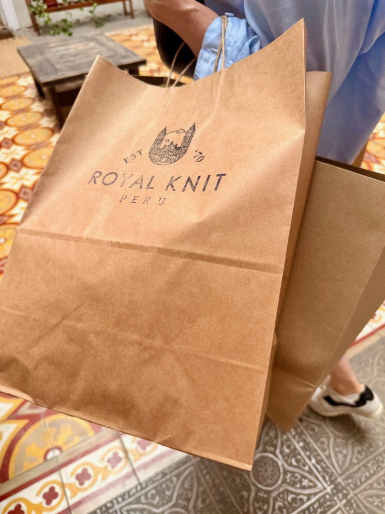 woman carrying royal knit shopping bag in barranco