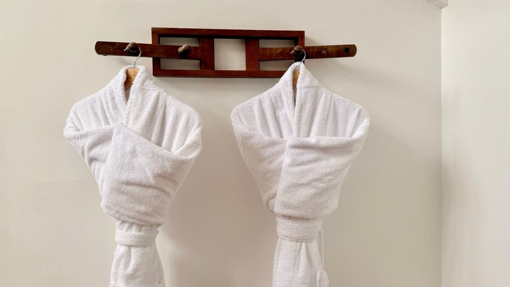 two neatly folded robes on a rack in a luxury hotel in lima