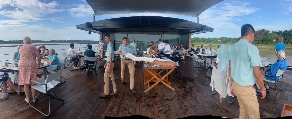 group of people gathered for breakfast on the deck of the Aqua Nera