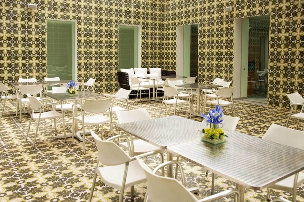 NM Lima Hotel — The lounge/breakfast area, with its bold patterned walls and clean white furniture