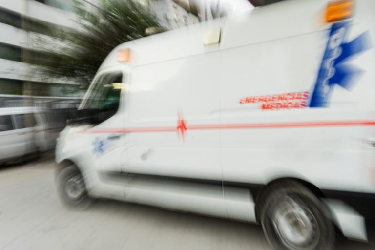 An ambulance driving in the city