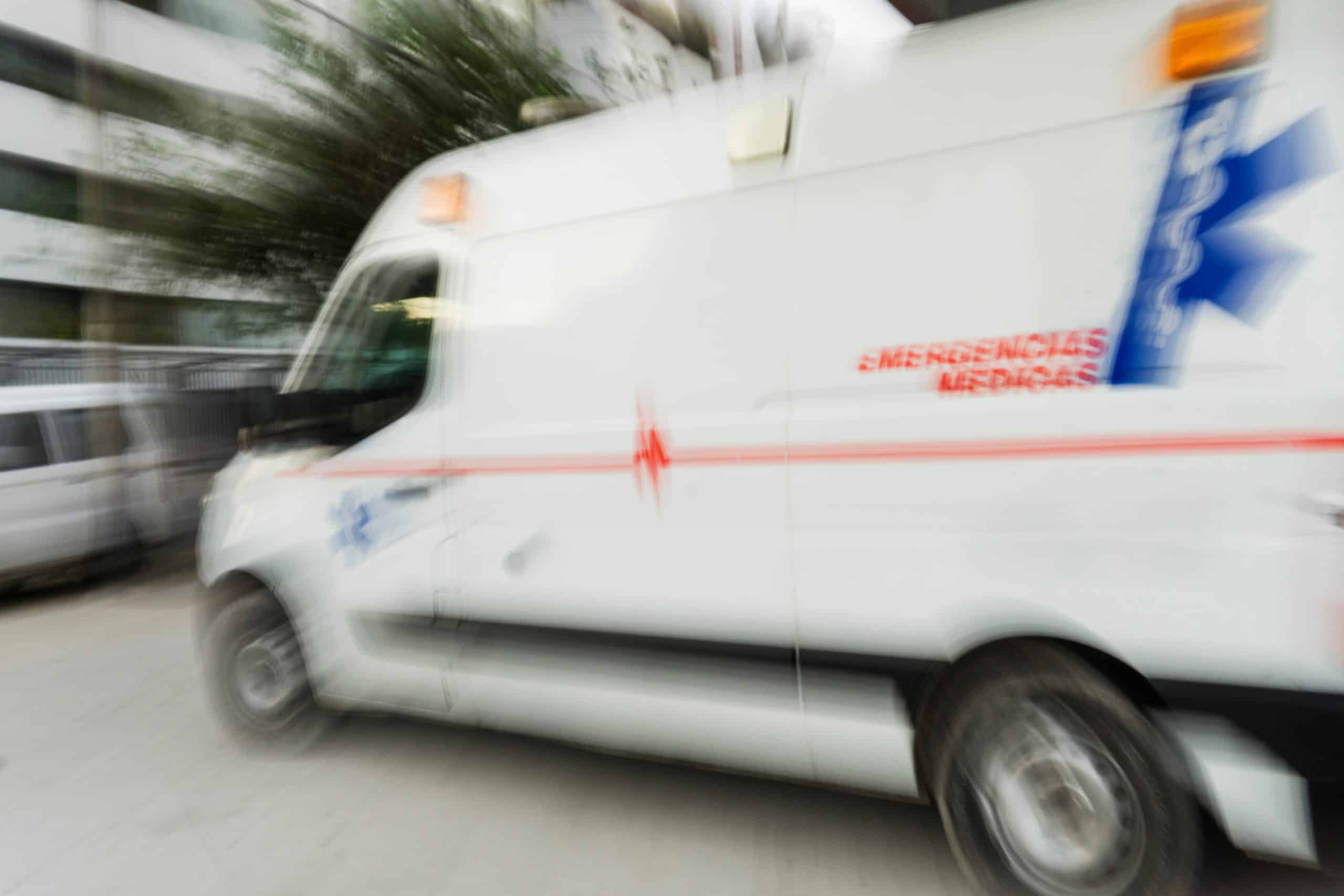 An ambulance driving in the city
