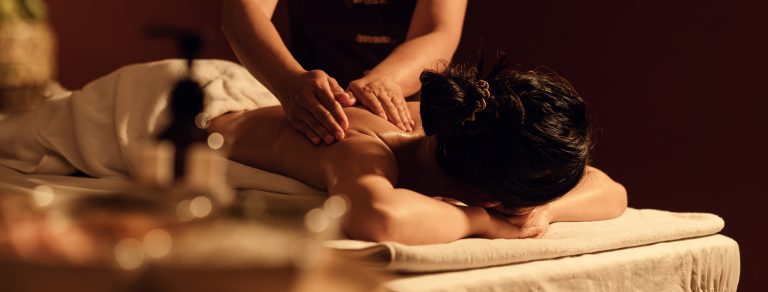 Relaxation woman back massage in cosmetology spa centre.